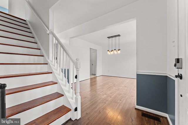 stairs with hardwood / wood-style flooring