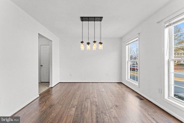 unfurnished dining area featuring hardwood / wood-style floors