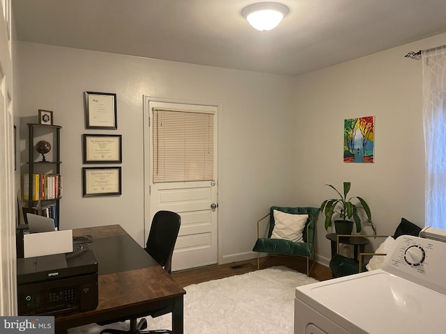 home office featuring washer / clothes dryer and dark hardwood / wood-style floors