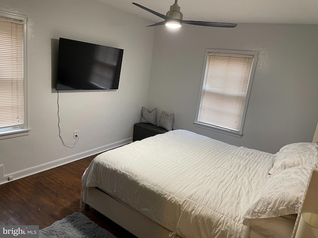 bedroom with lofted ceiling, ceiling fan, and dark wood-type flooring