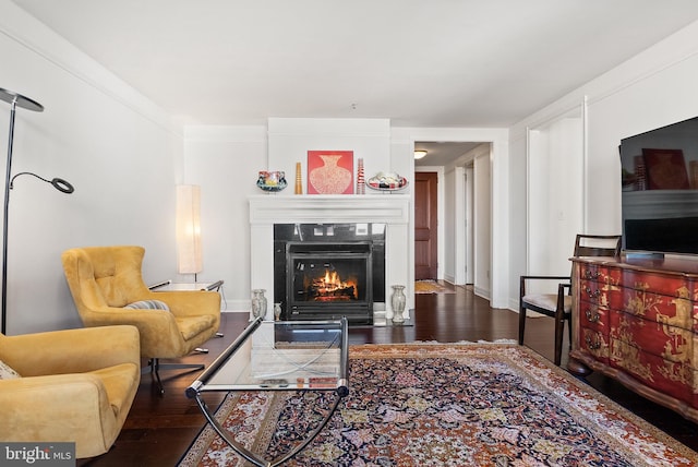 living room featuring dark hardwood / wood-style flooring and crown molding