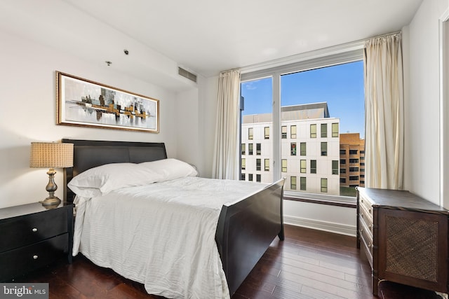 bedroom with dark hardwood / wood-style flooring