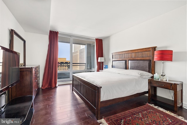 bedroom with dark wood-type flooring