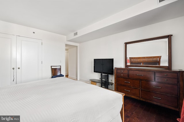 bedroom with dark hardwood / wood-style flooring