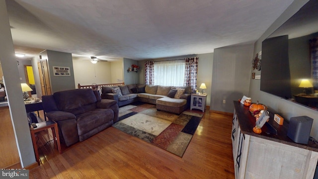 living room featuring hardwood / wood-style flooring and ceiling fan