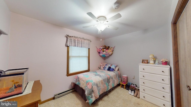 bedroom with ceiling fan, a closet, light colored carpet, and a baseboard radiator