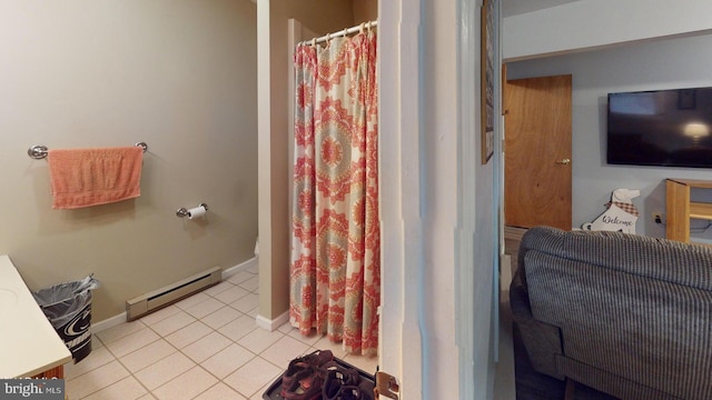 bathroom featuring tile patterned flooring, vanity, and a baseboard heating unit