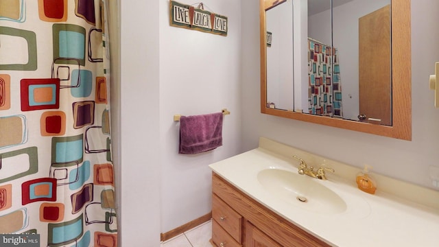 bathroom with tile patterned floors, vanity, and water heater