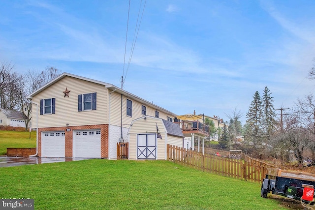 rear view of property with a garage and a yard