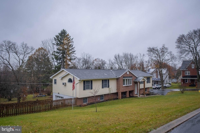 view of front of property featuring a garage and a front lawn