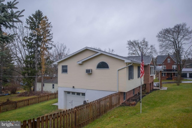 view of home's exterior with a yard and a garage