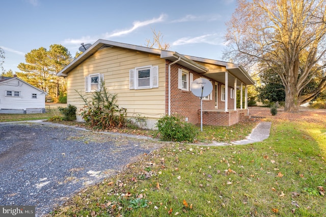 view of side of home featuring a yard