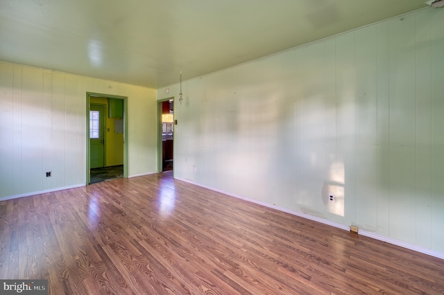 unfurnished room with wood-type flooring