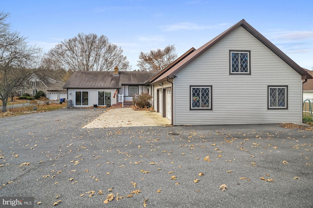 back of house with a garage