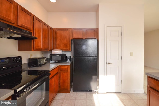 kitchen featuring black appliances and ventilation hood