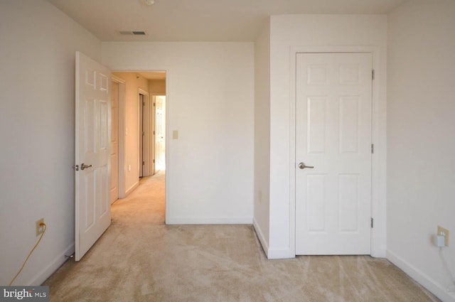 hallway with light colored carpet