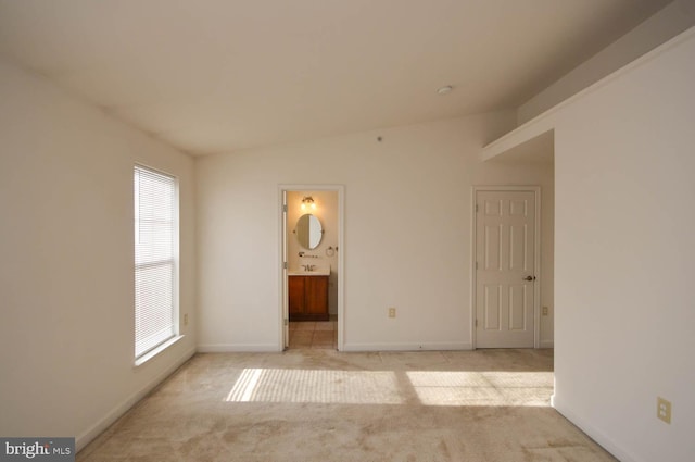 carpeted empty room featuring vaulted ceiling