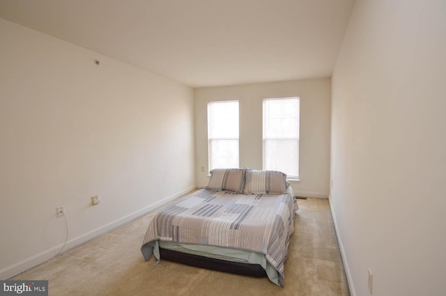 bedroom with light colored carpet