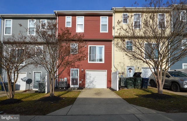 view of front of property featuring central AC unit and a garage