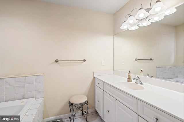 bathroom featuring tile patterned flooring, vanity, and a relaxing tiled tub