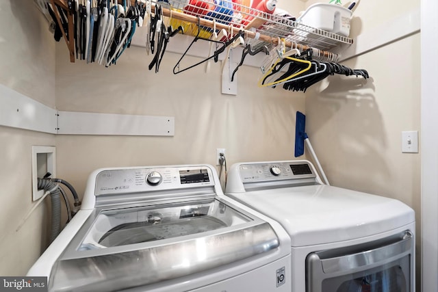 clothes washing area featuring washer and clothes dryer