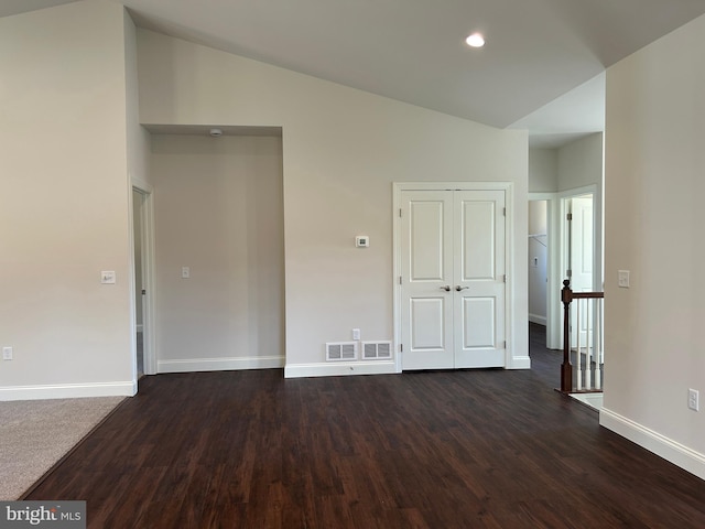 interior space featuring dark hardwood / wood-style flooring and vaulted ceiling