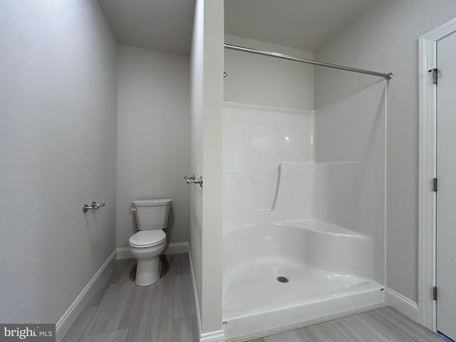 bathroom with hardwood / wood-style floors and toilet