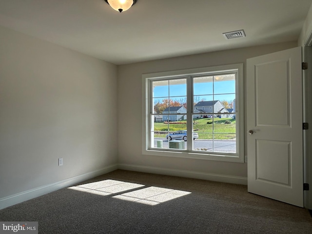 empty room featuring dark carpet