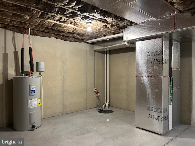 basement with electric water heater and heating unit