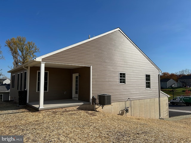 rear view of property featuring central AC