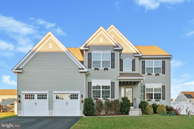 view of front of house with a front yard and a garage