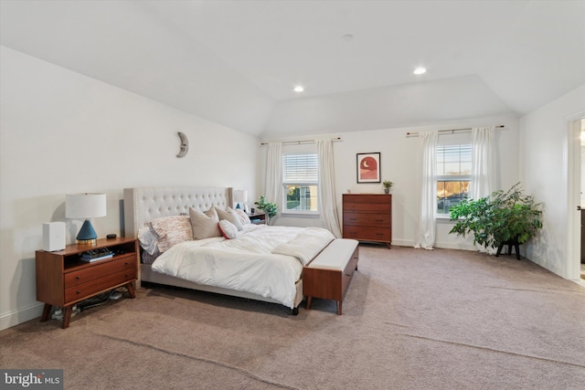 bedroom with light colored carpet and vaulted ceiling