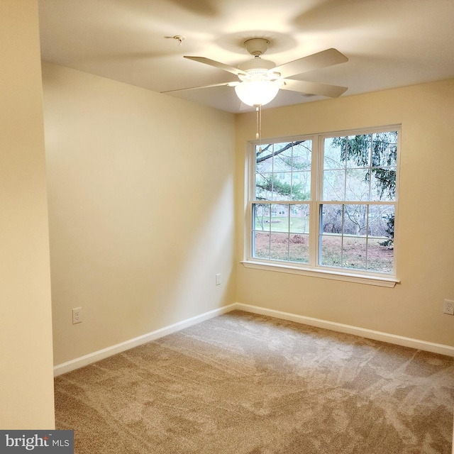 carpeted empty room featuring ceiling fan