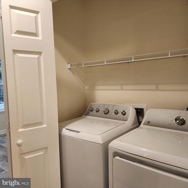 clothes washing area featuring independent washer and dryer