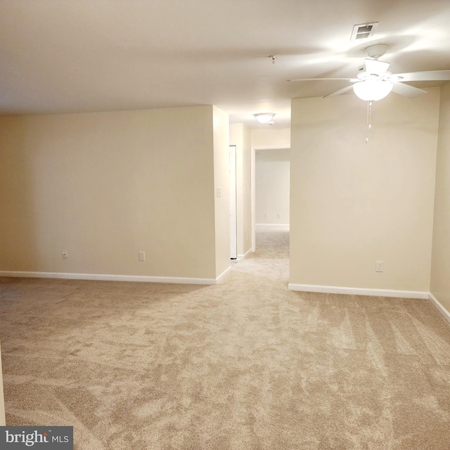 carpeted spare room with ceiling fan