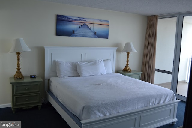 carpeted bedroom featuring a textured ceiling