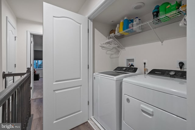 laundry room featuring washing machine and dryer and wood-type flooring