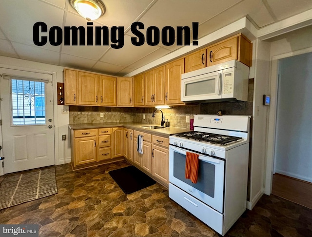 kitchen featuring sink, a drop ceiling, light brown cabinets, tasteful backsplash, and white appliances