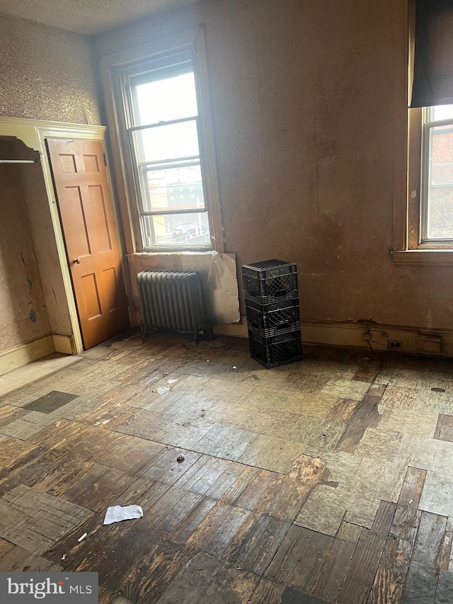 unfurnished bedroom with radiator and light hardwood / wood-style flooring