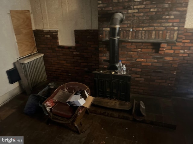 living room with a wood stove and dark wood-type flooring