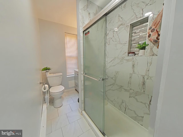 bathroom with tile patterned floors, toilet, and a shower with door