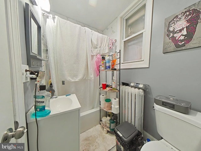 full bathroom with vanity, toilet, radiator, and shower / tub combo