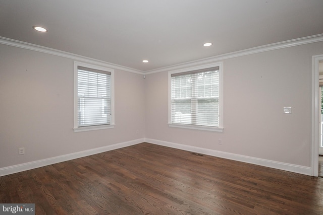 unfurnished room with ornamental molding and dark wood-type flooring