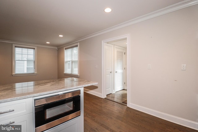 kitchen with crown molding, white cabinets, and dark wood-type flooring