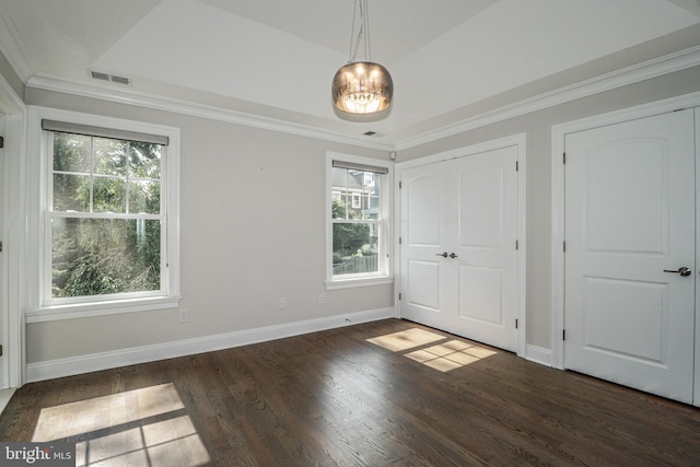 unfurnished bedroom featuring dark hardwood / wood-style flooring, ornamental molding, and multiple windows