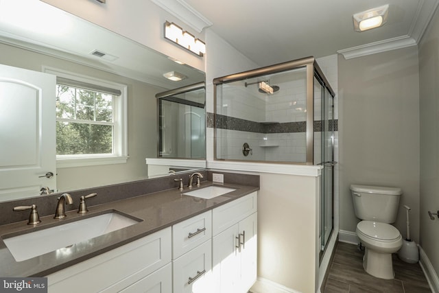 bathroom with an enclosed shower, vanity, toilet, and ornamental molding