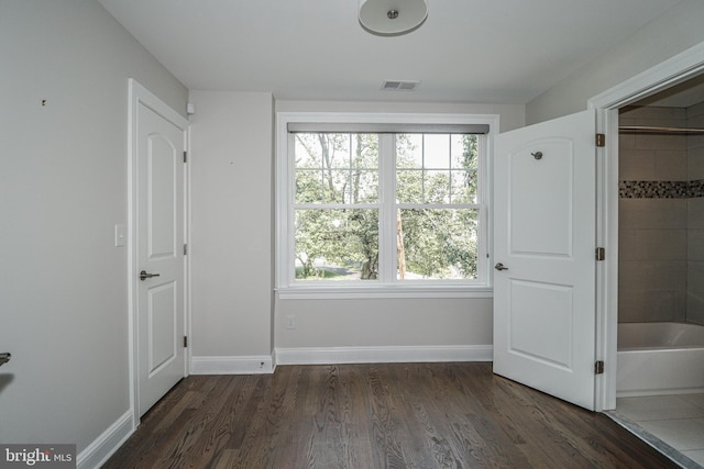 unfurnished bedroom featuring dark wood-type flooring