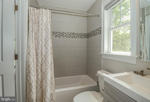 full bathroom with vanity, a healthy amount of sunlight, toilet, and shower / tub combo with curtain