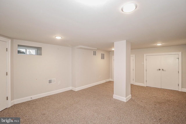 basement featuring light carpet