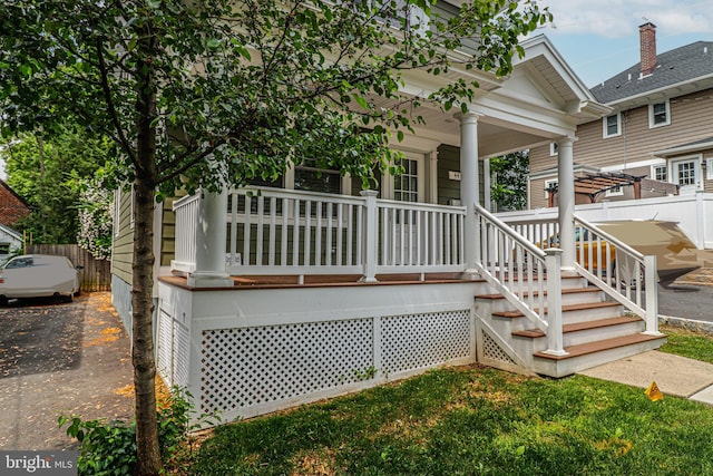 rear view of house featuring a porch